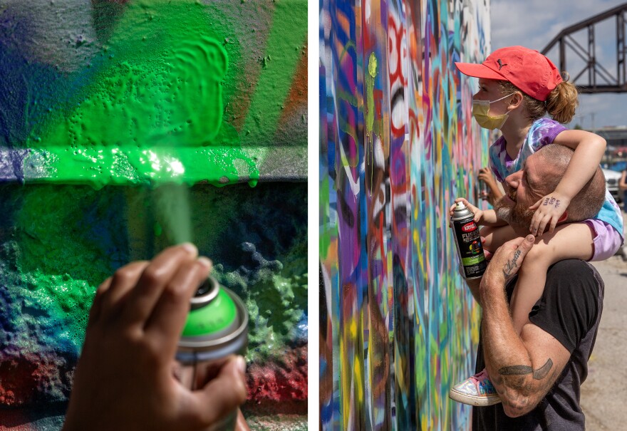 A diptych of two vertical images. The left image is a close up of a young Black girl's hand spraying green paint at a wall, with the paint collecting and dripping from the intensity of the spray. The picture's focus is on the wall, rather than the hand. The right image is of a young White girl wearing a red ball cap, sitting atop the shoulders of a White man in a black t-shirt. The pair are standing in front of a graffiti-covered wall. 