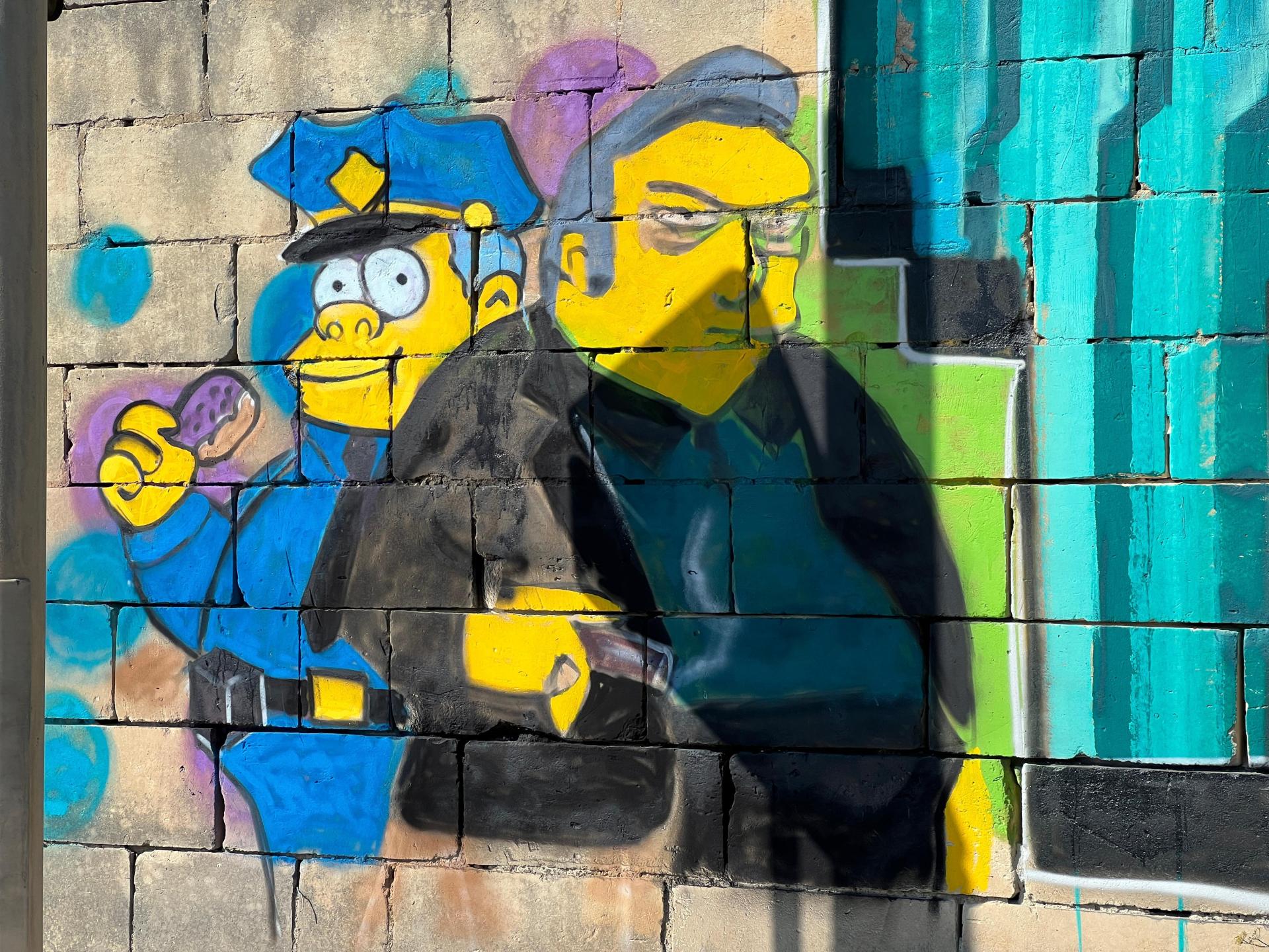 Uncaring police officers and the looming shadow of organised crime also appear to be depicted in the graffiti. Photo: Chris Sant Fournier