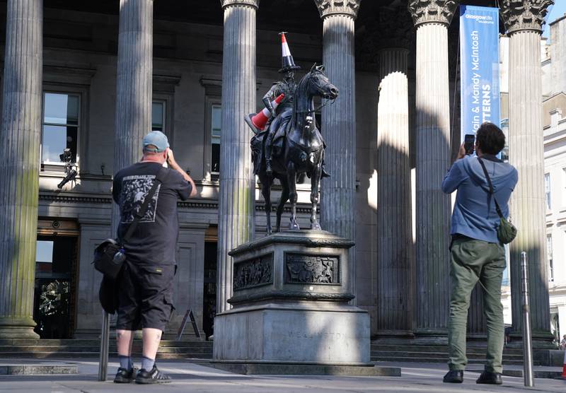 The Duke of Wellington statue outside the Gallery of Modern Art in Glasgow, which has been adorned with a new traffic cone - with a black stripe and a propeller on top. PA 