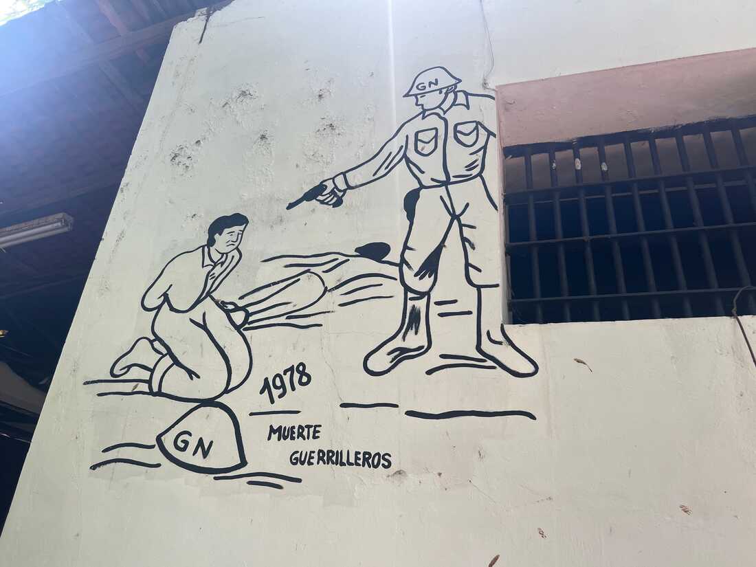 A mural depicts a national guardsman about to execute a guerrilla fighter. 