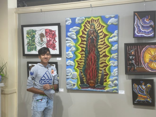 Petal artist Brallan Martinez shows off some of his artwork in the 