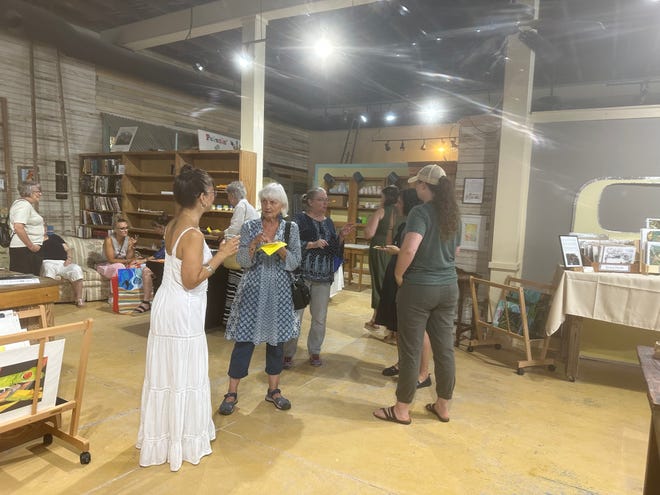 Hattiesburg, Miss., artists Hector Boldo and Jacqueline Wooton talk to guests at the opening reception Saturday, Sept. 2, 2023, for their show, 