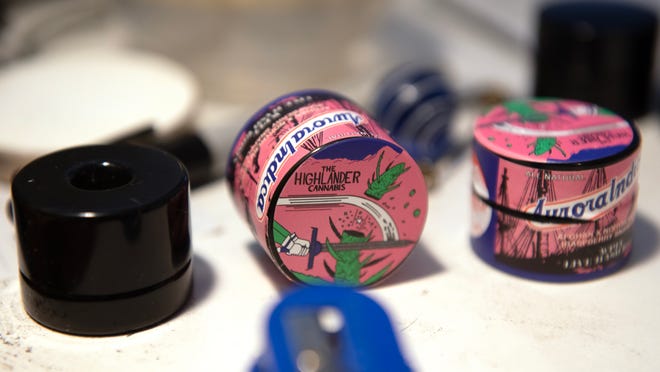 Cannabis containers designed by cartoonist Brian Box Brown, a New Jersey native now living in Philadelphia, are displayed in the basement studio of Brown's home.
