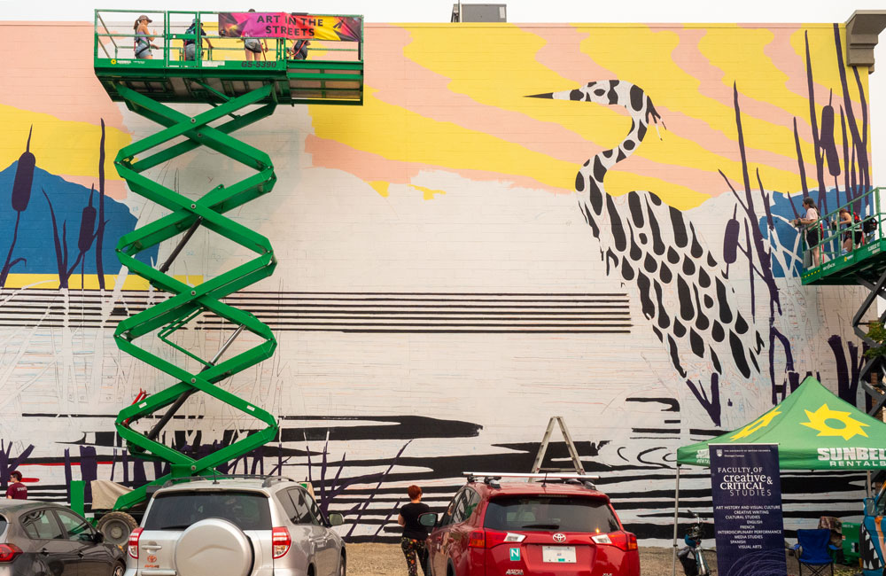A wide shot of the mural in progress