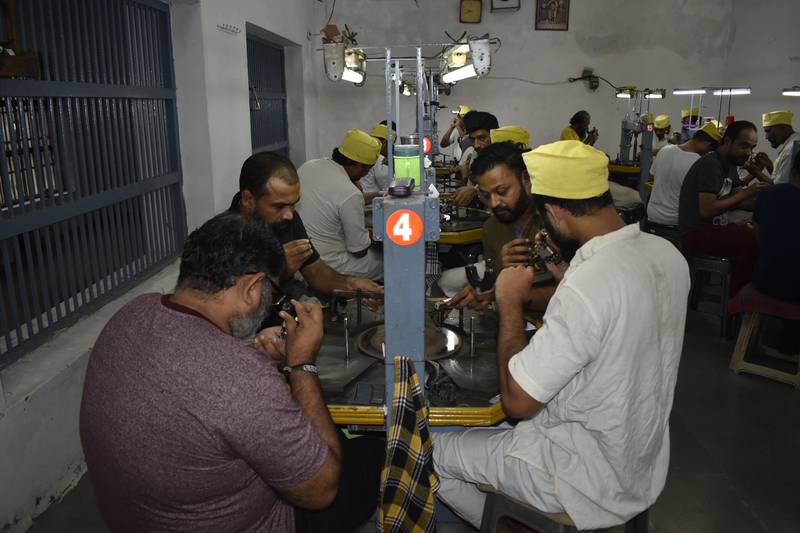 Prisoners work in groups of four at the diamond-polishing workshop at Lajpore Central Jail in Surat, India. Photo: Lajpore Central Jail