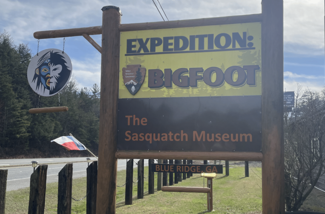 A photo of the welcome sign to the Big Foot Museum. Blue Sky in the background