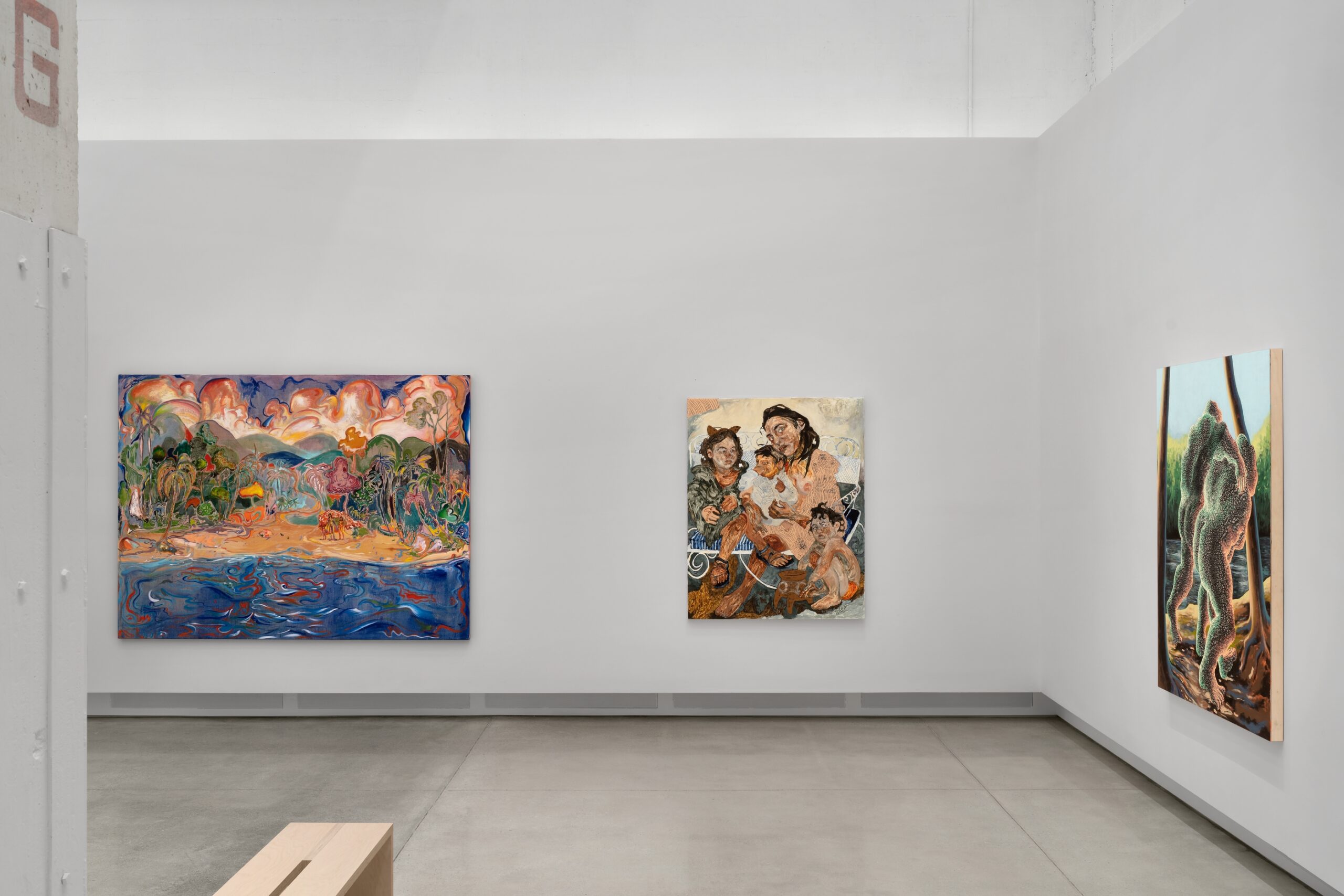Three paintings hang on white wall in gallery 