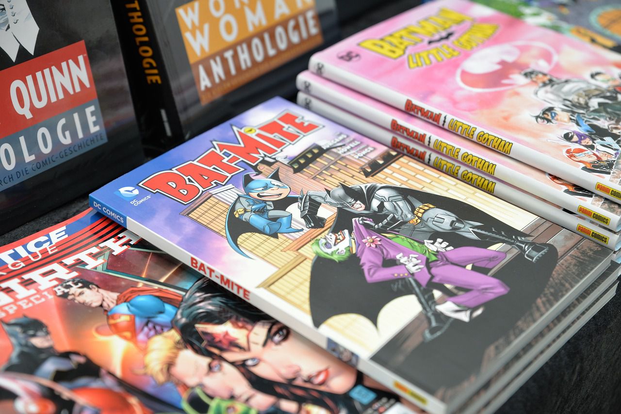 A photo of a Bat-Mite comic, placed between a Justice League comic on the left and a Batman comic on the right.