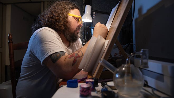 Cartoonist Brian Box Brown, a New Jersey native, works in the basement studio of his Philadelphia home. Brown turned cannabis into his pet project with 