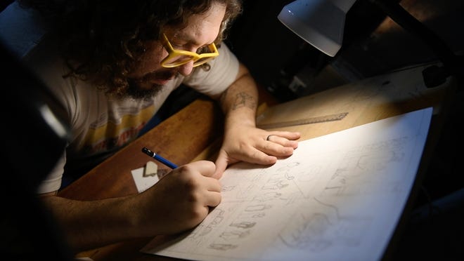 Cartoonist Brian Box Brown, a New Jersey native, works in the basement studio of his Philadelphia home. Brown turned cannabis into his pet project with 