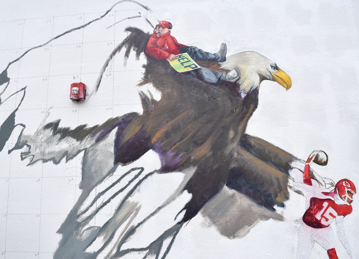 A mural shows a bald eagle grabbing Chiefs player Mahomes while coach Andy Reid is caught in the wings.