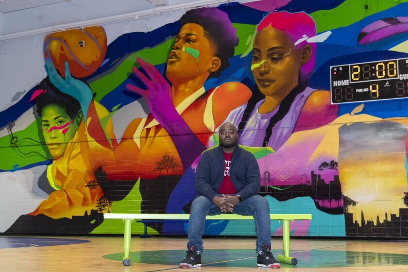 Artist Max Sansing shown in 2020 in front of one of his indoor murals.