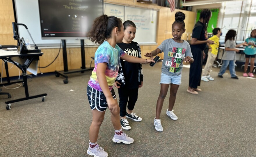 Students do improvisation using a whiteboard eraser during theatre arts and dance class at Webster Elementary, San Diego, Calif., Oct. 18, 2023