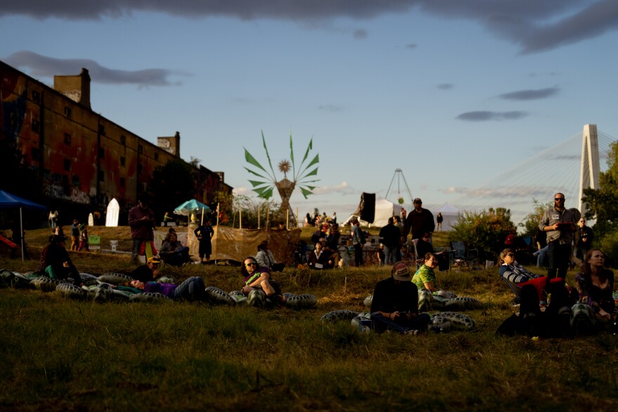 Dozens of festival goers listen to live music on Sunday, Oct. 8, 2023, during the Artica Urban Art Festival along the Mississippi Riverfront in downtown St. Louis.
