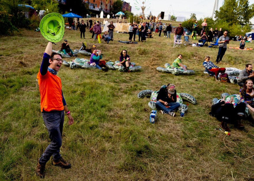 Eric Woelbling, 33, of Northampton, reacts as the artist Eldraco hits a high note on Sunday, Oct. 8, 2023, during the Artica Urban Art Festival along the Mississippi Riverfront in downtown St. Louis. “This festival is an opportunity for free expression and like-minded artistic people to get a new sense of inspiration and imagination,” the painter said.