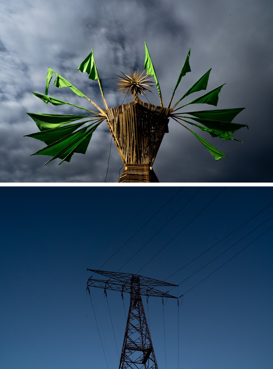 A wooden effigy of “Our Lady of Artica” stands juxtaposed by its inspiration — a power transformer on the grounds of the Artica Urban Art Festival — on Sunday, Oct. 8, 2023, along the Mississippi Riverfront in downtown St. Louis.