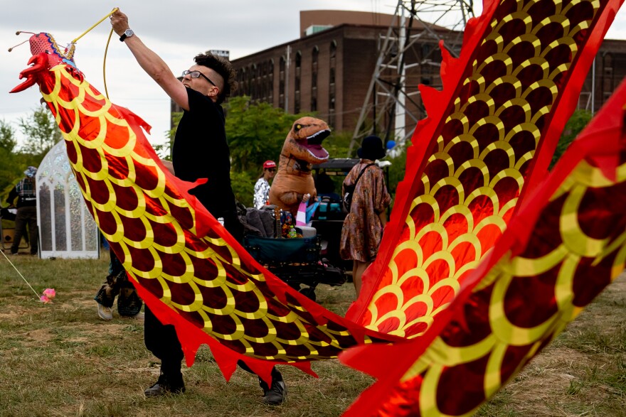 Peter Schroeder, 38, of Dutchtown, performs with a Chinese dragon on Sunday, Oct. 8, 2023, during the Artica Urban Art Festival along the Mississippi Riverfront in downtown St. Louis. Schroeder said he has been coming to the festival for the last four years. “No matter what your art is, you can come and do it out here for a receptive audience who thinks it’s the coolest thing ever.”
