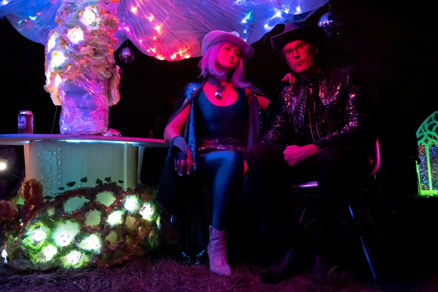 Audrey Simes, 33, and Drew Sheafor, 38, both of Tower Grove South, sport their festival looks while under a glowing mushroom on Sunday, Oct. 8, 2023, during the Artica Urban Art Festival along the Mississippi Riverfront in downtown St. Louis.