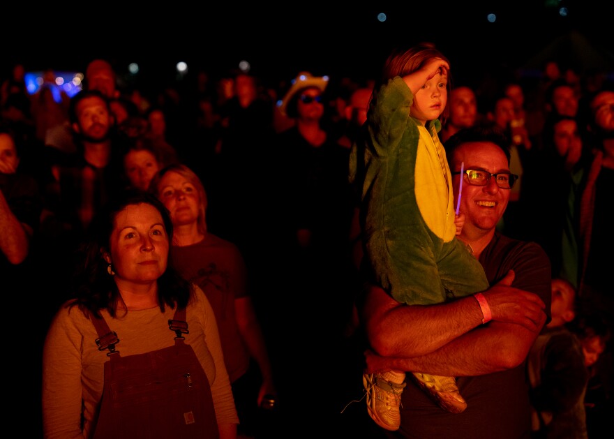 Alex Pennington, 40, of Benton Park, smiles as he and his daughter Ursula, 3, watch as “Our Lady of Artica” burns on Sunday, Oct. 8, 2023, at the conclusion of the Artica Urban Art Festival on the Mississippi Riverfront in downtown St. Louis. Lacy Cagle, 40, of Benton Park, stands to their right.
