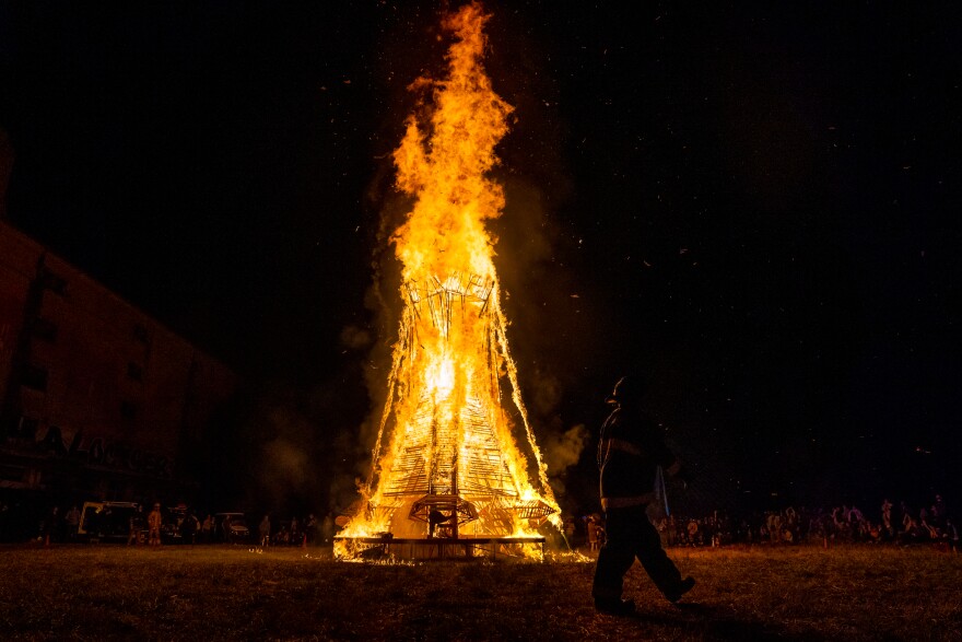 Hundreds watch as “Our Lady of Artica” burns on Sunday, Oct. 8, 2023, at the conclusion of the Artica Urban Art Festival on the Mississippi Riverfront in downtown St. Louis.