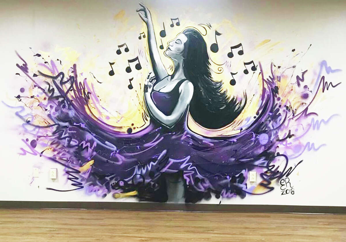 Meriden artist, hairstylist and hip-hop musician Eddie Rivera recently completed a portion of a giant, floral-themed mural in the back alleyway of 418-20 Main St. in Middletown. He's also done murals around the state.