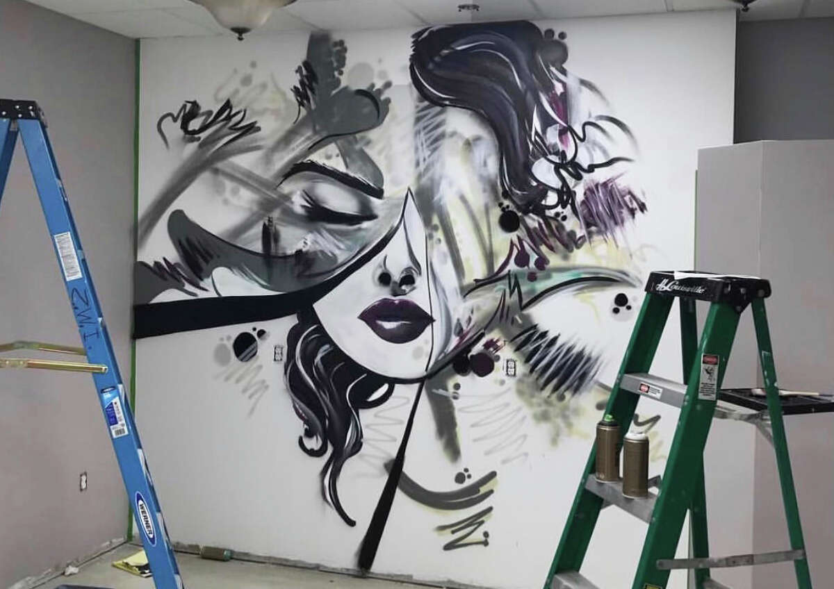 Meriden artist, hairstylist and hip-hop musician Eddie Rivera recently completed a portion of a giant, floral-themed mural in the back alleyway of 418-20 Main St. in Middletown. He's also done murals around the state.