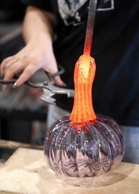 Jessica Khalil finishes one of her final glass pumpkins at the First City Art Center on Tuesday, Oct. 3, 2023. First City will hold its 17th annual Glass & Ceramic Pumpkin Patch this weekend, beginning with a preview on Friday, Oct. 6.