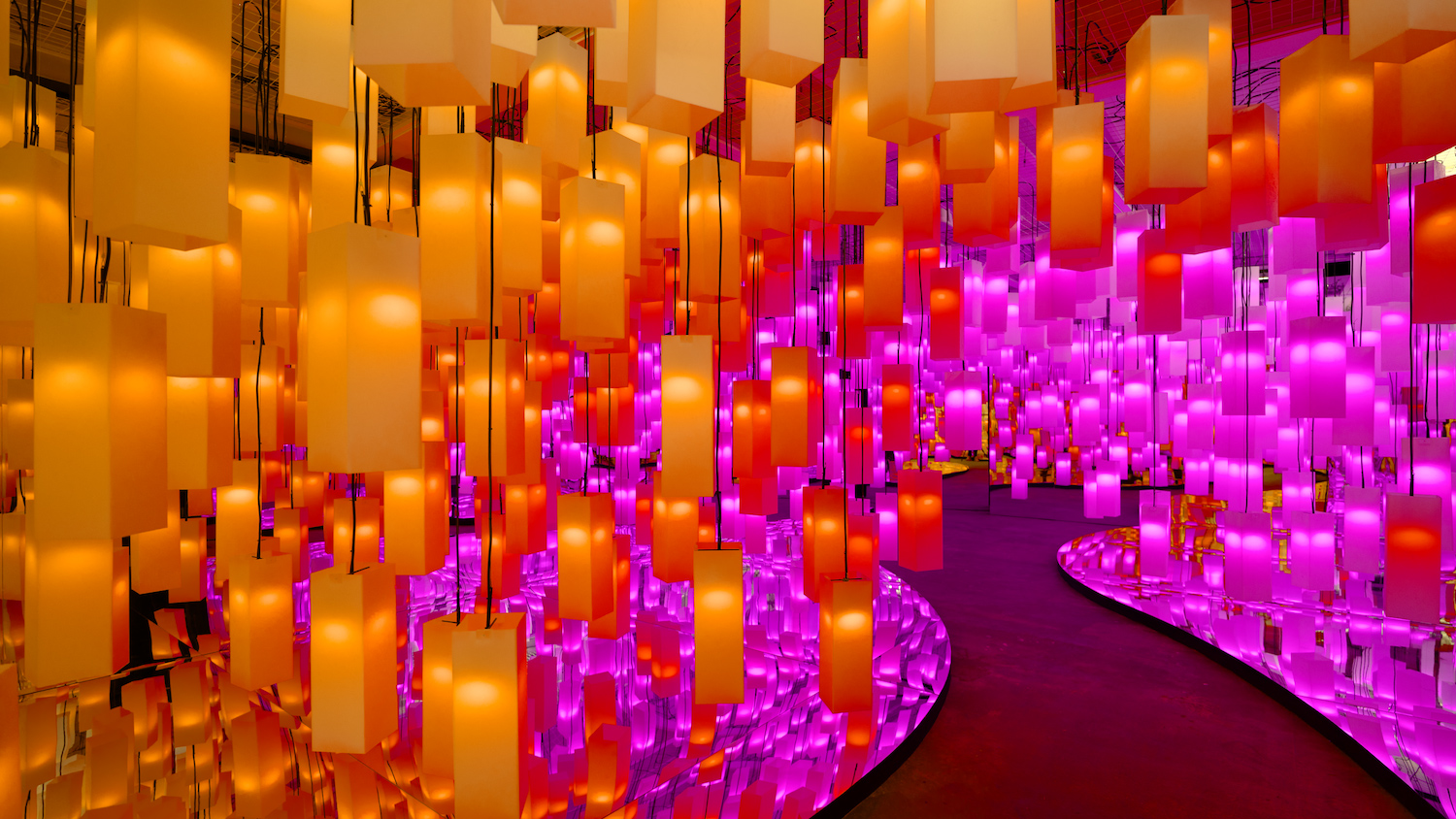 Installation view of '631' features flickering candles and vibrant cerise neon lights