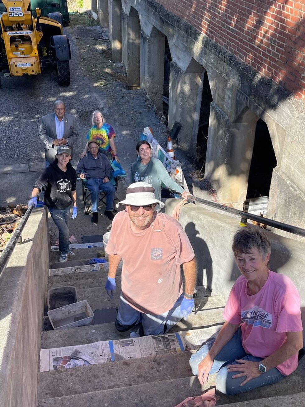 Volunteers working to turn ordinary stairs into a work of art in downtown Wetumpka.