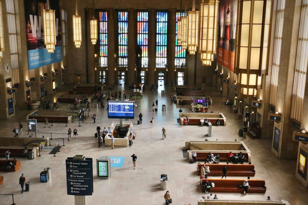 A view from above of ‘’Euphonic & Chromatic Drift,” a mural in translucent vinyl, covers the soaring windows at the east and west ends of the 30th Street Station main concourse