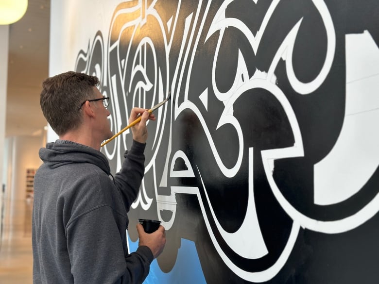 A man painting a mural