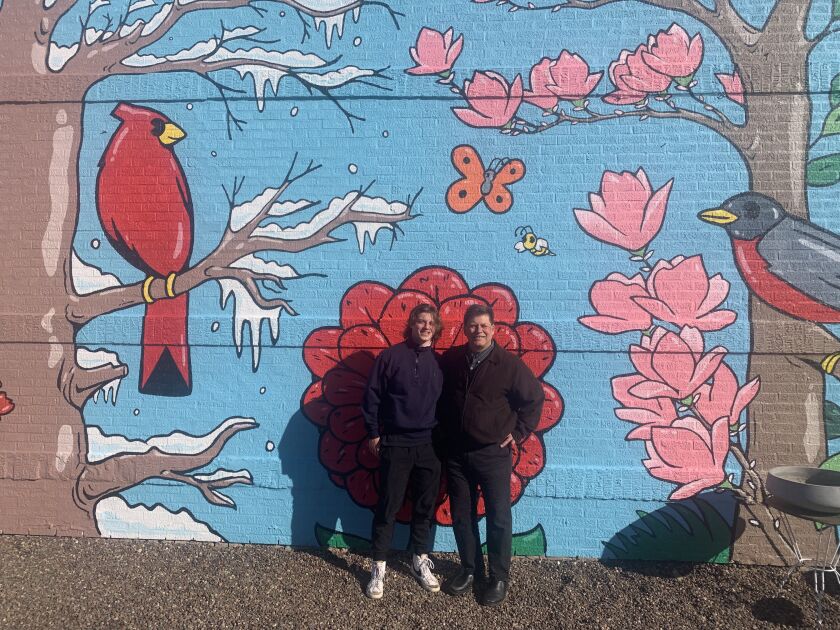 Gerry Luc (left) and his father Terry Luc in front of their Northbrook mural.