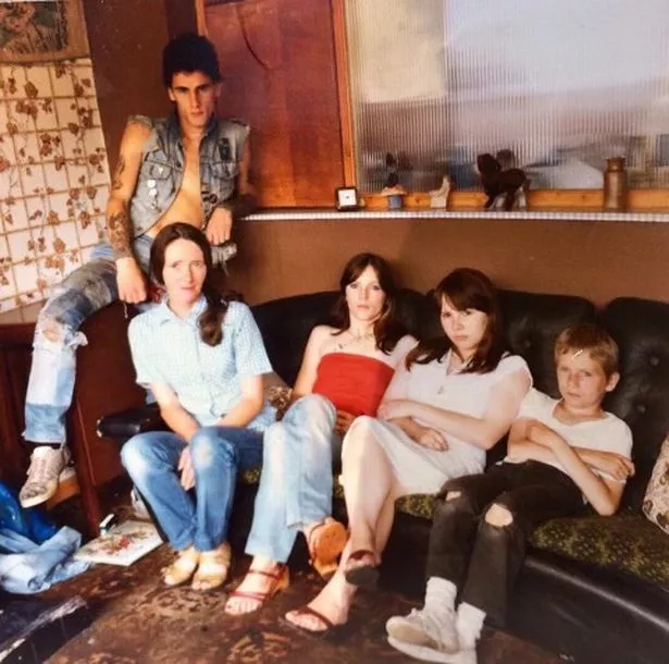 Growing up in Egremont in Wallasey, John Paul Hughes and his family were photographed in their home by Tom Wood for several years. Pictured left to right, John Paul, mum Brenda, sister Collette, sister Carol and younger brother Andy