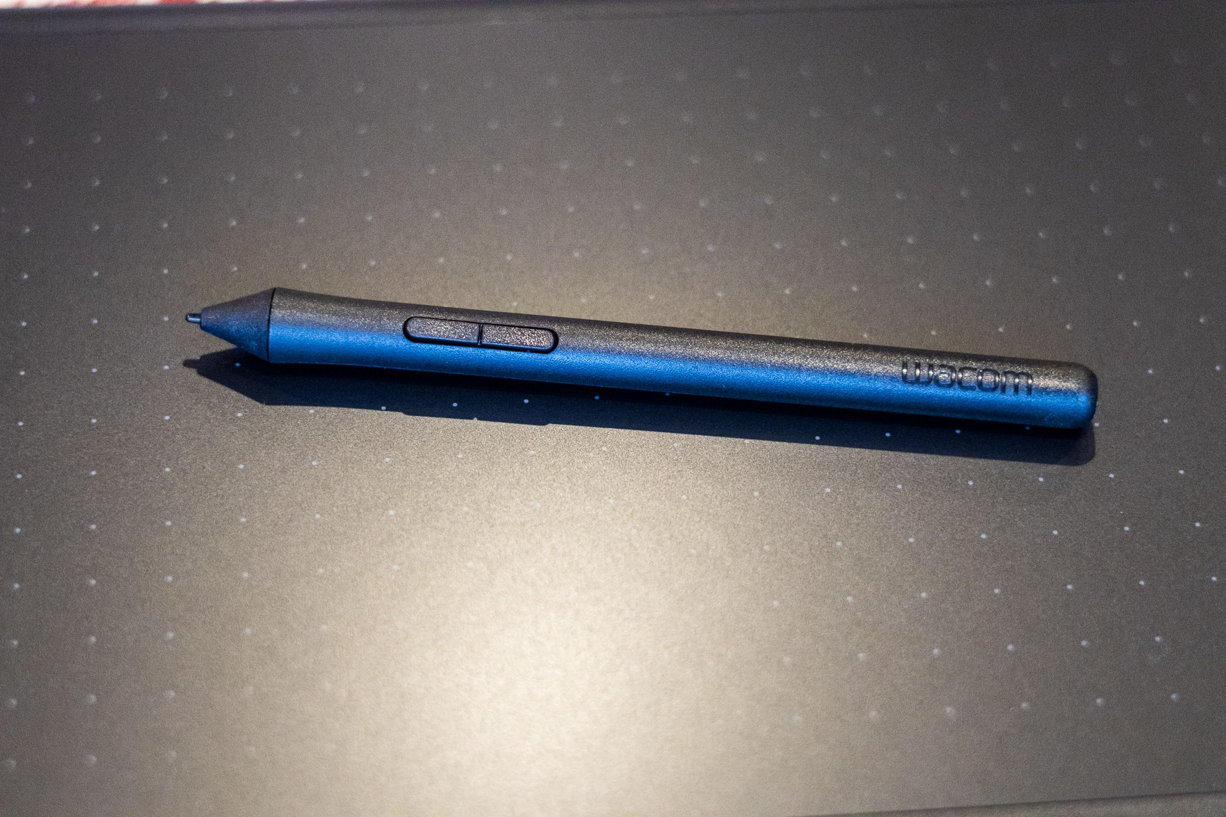 The One by Wacom stylus resting against the Wacom tablet.