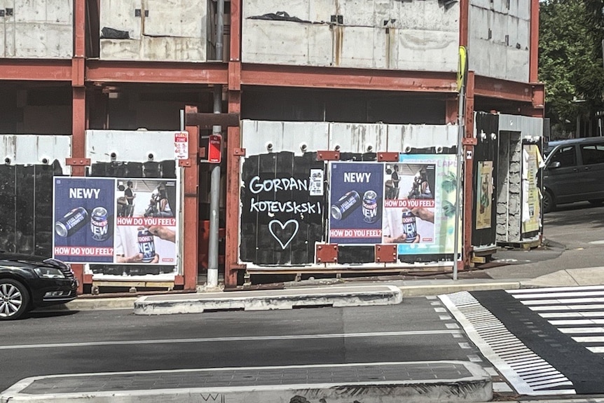 Graffiti on the side of construction scaffolding in Newcastle that reads 'Gordana Kotevski' and the symbol of a love heart