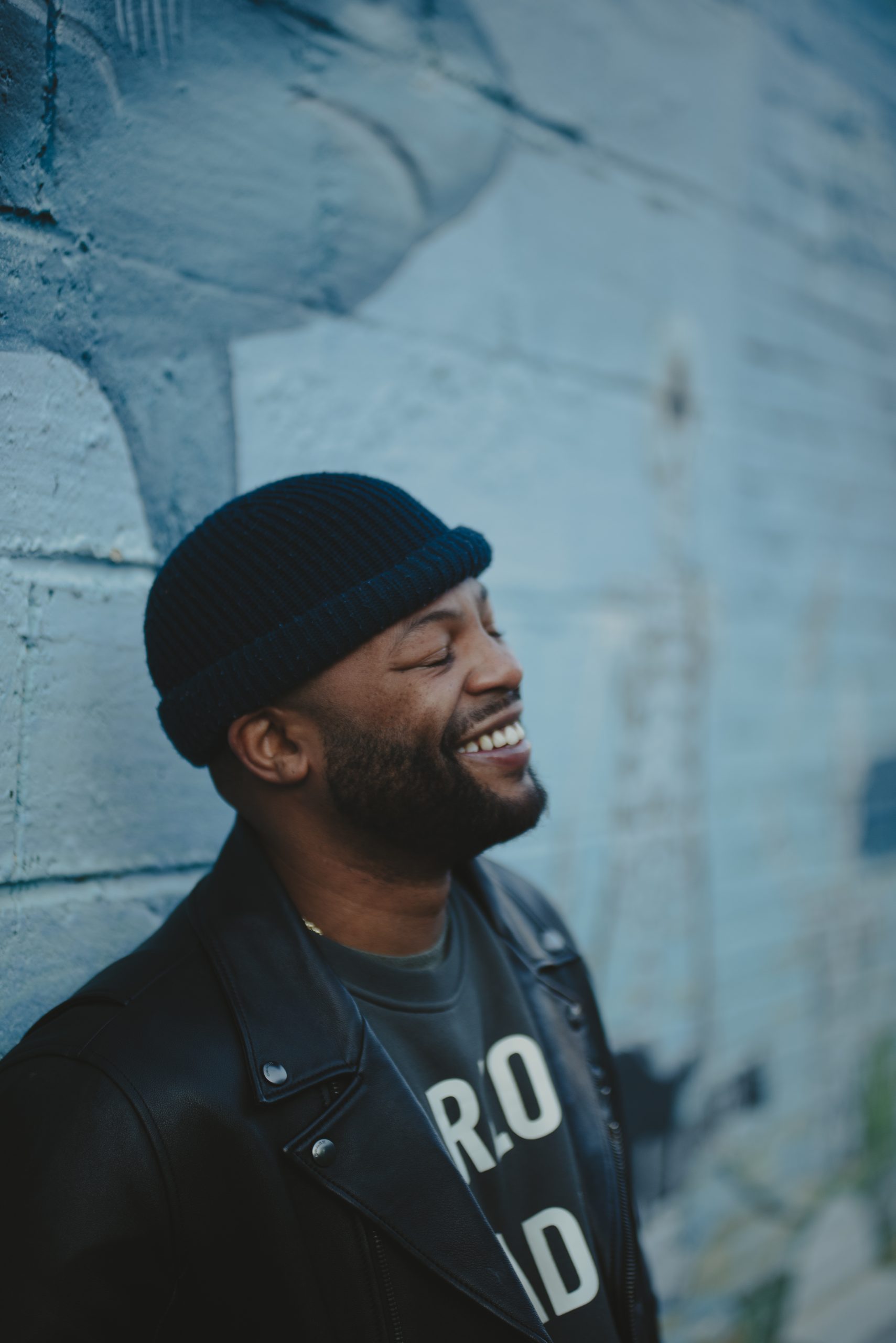A photo of Mason Parker smiling with a blue-walled background in Charlotte, NC.