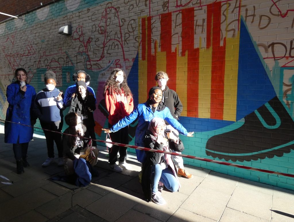 Art students from Enfield County School beside the mural as it begins to take shape