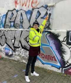 Cllr James McAsh pitched in with the graffiti removal