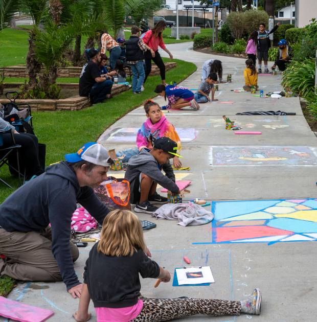 Children of all ages participate in the Chalktastic chalk art...