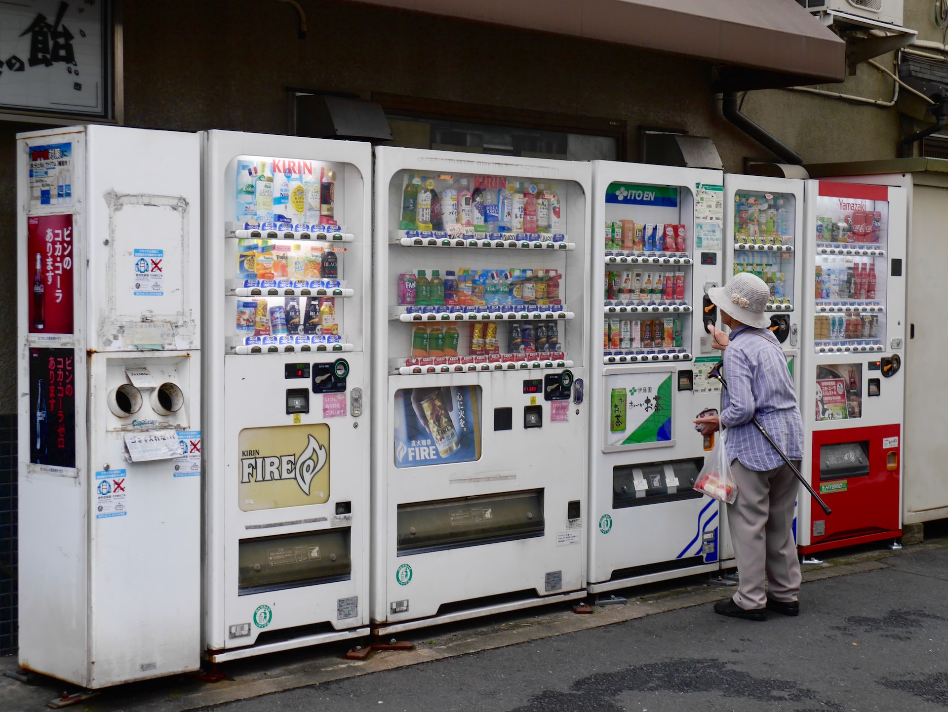 Five vending machines in Japan A woman standing in front of five vending machines in Japan.