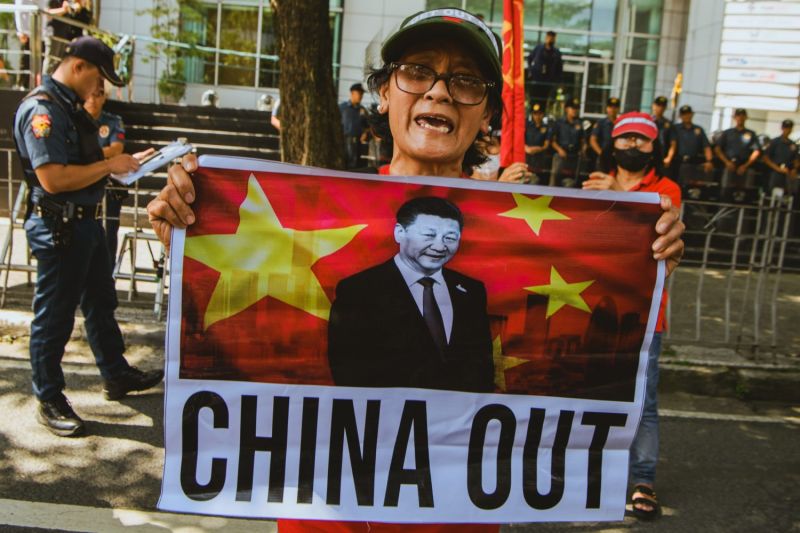 A protester holds a placard reading