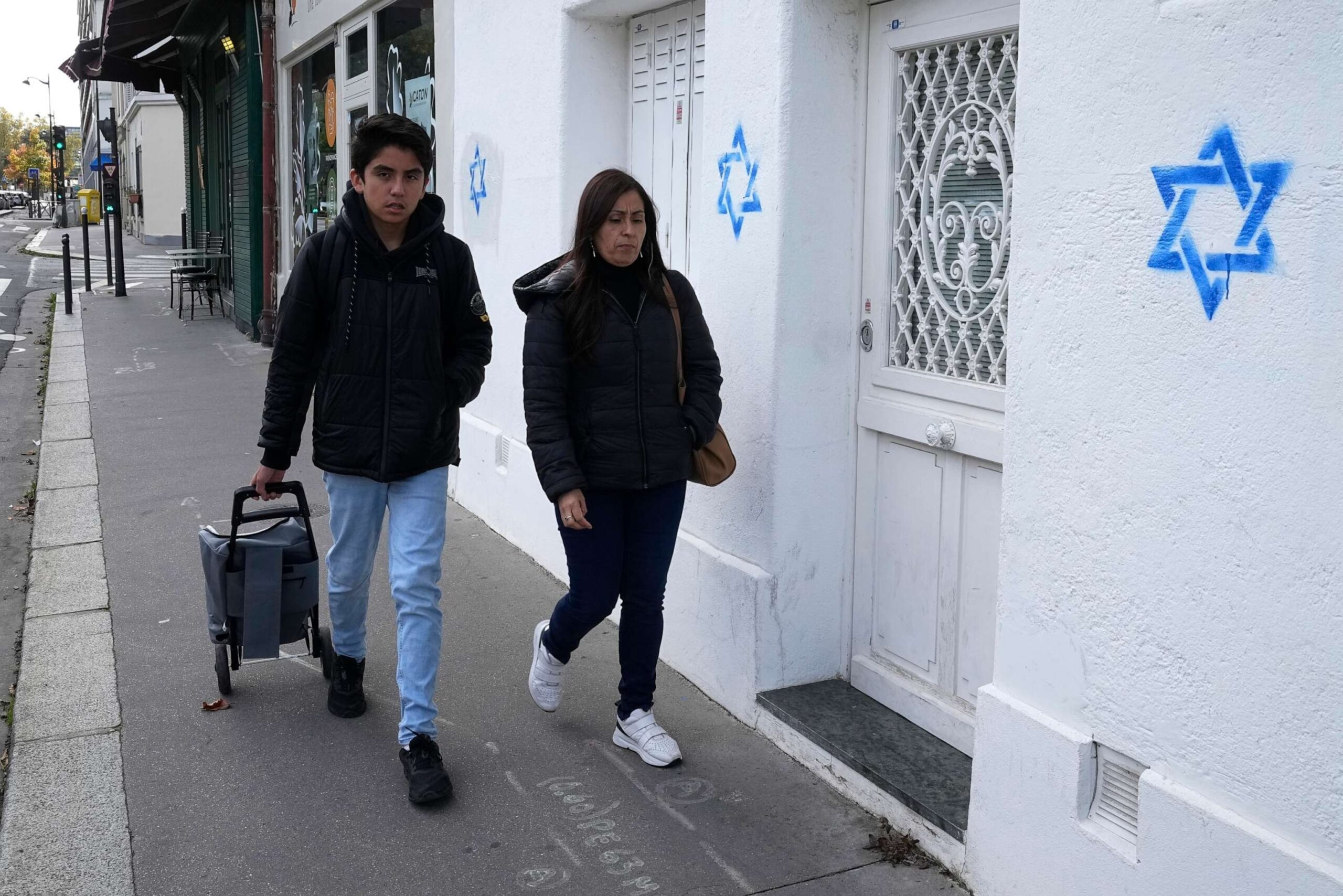 PHOTO: People walk by Star of David symbols tagged on a wall Tuesday, Oct. 31, 2023, in Paris.
