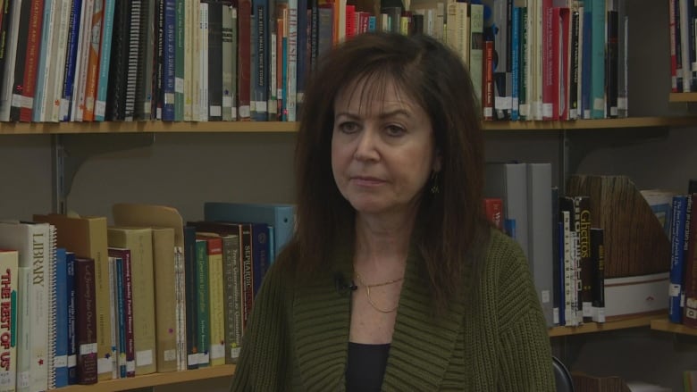 A woman in a green sweater.