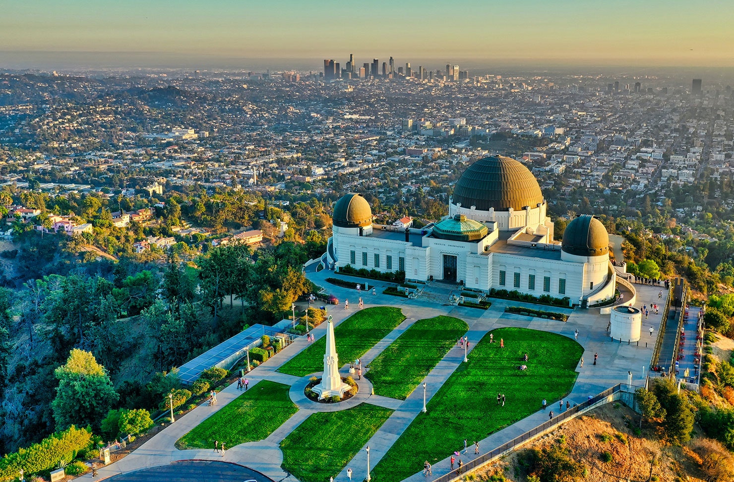 an observatory with a dome roof in the middle of a city on a hill