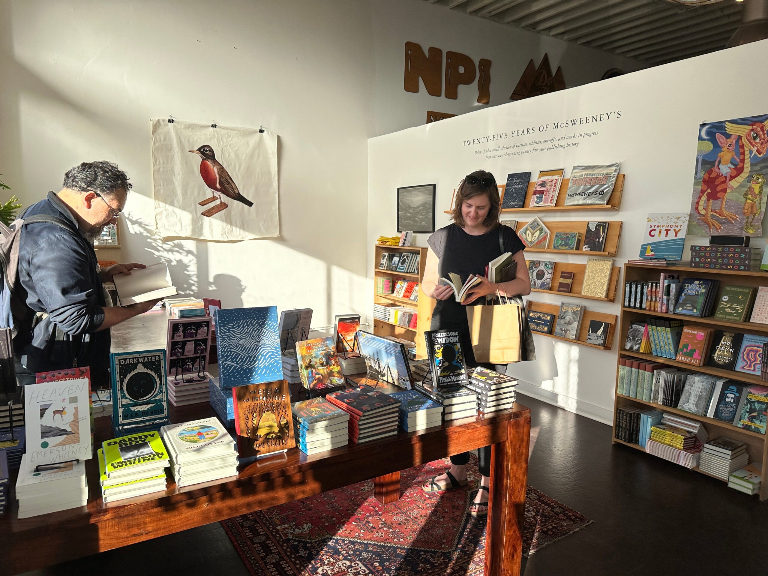 A man and a woman flip through a pop-up bookshop on San Francisco's Valencia Street.