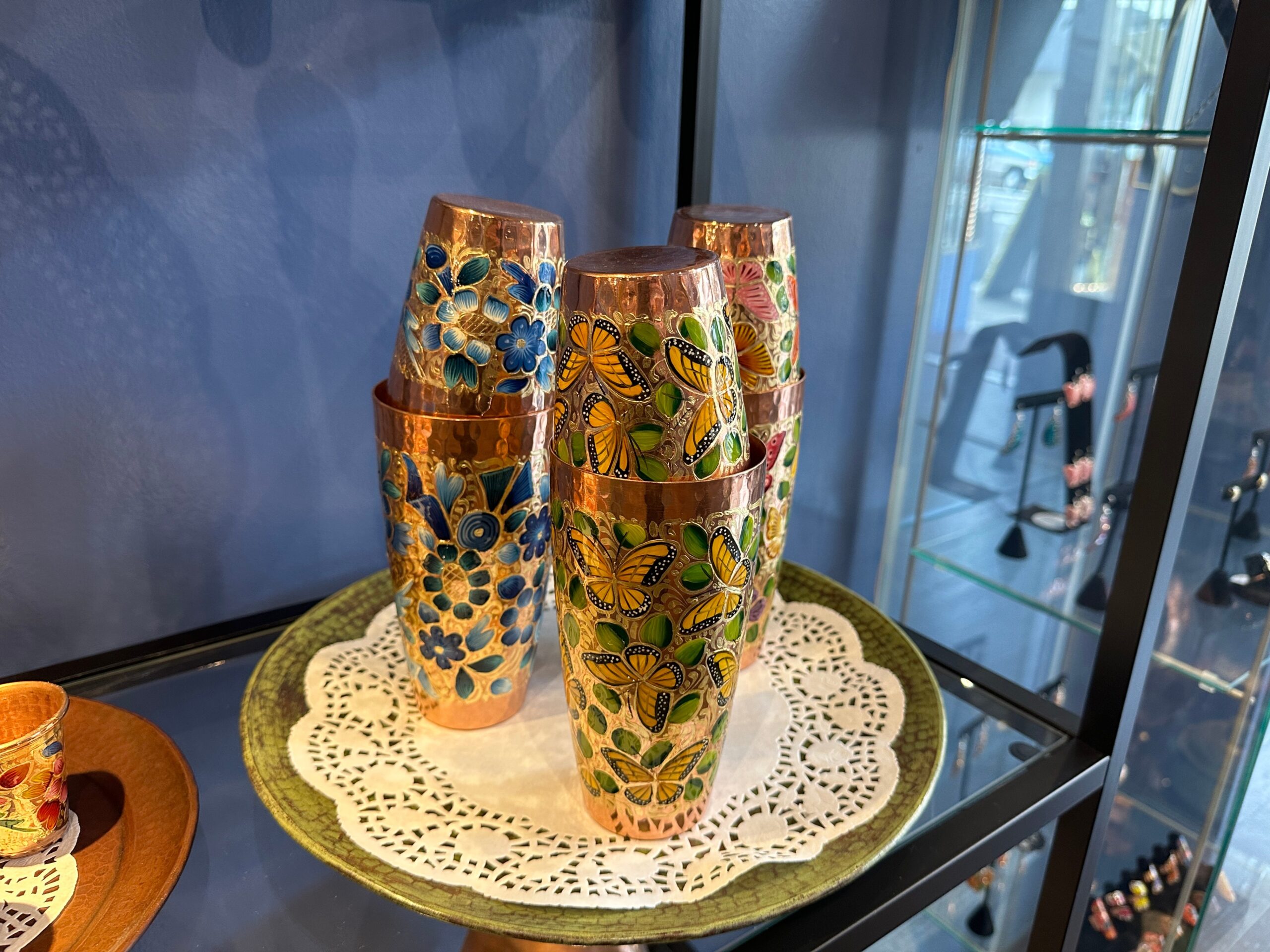 Copper cocktail shakers with hand-painted flower and butterfly designs are put on display in a copper shop and gallery in San Francisco on Valencia Street. 