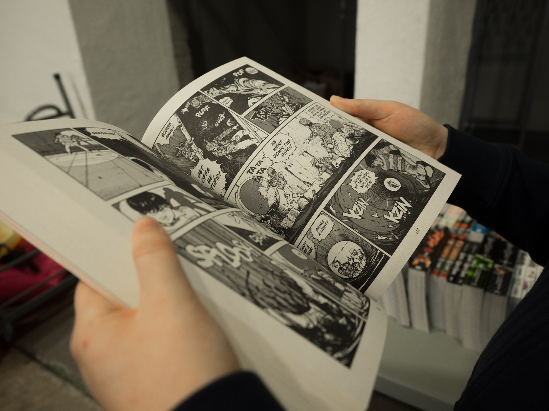 person reading a manga book A person reading a manga book.