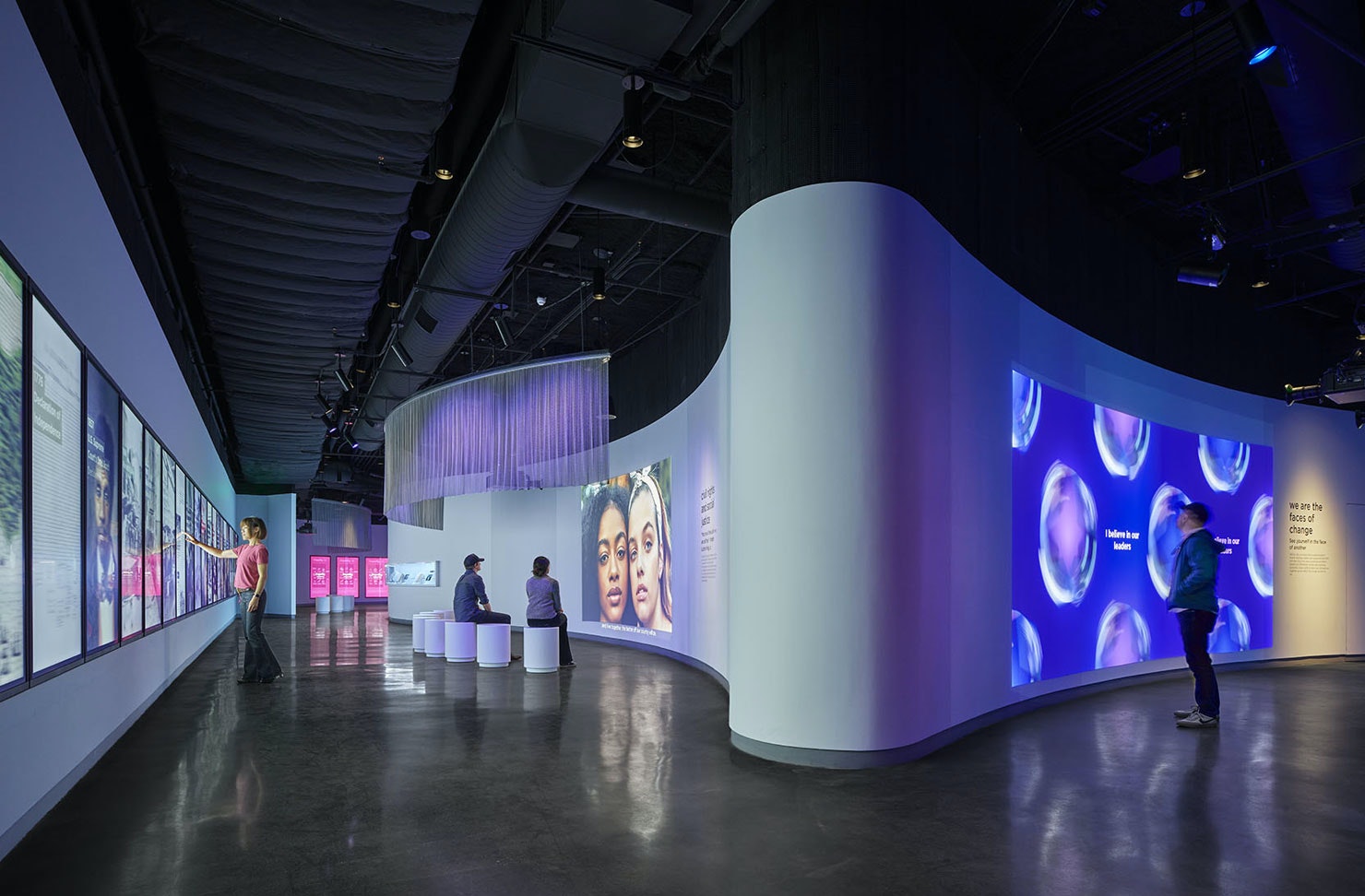 a museum with art in it and people walking around