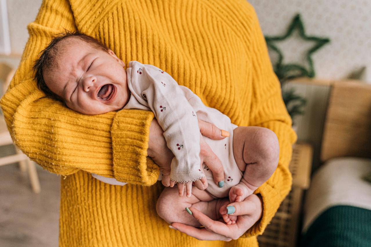 Person holding crying baby Person holding crying baby.