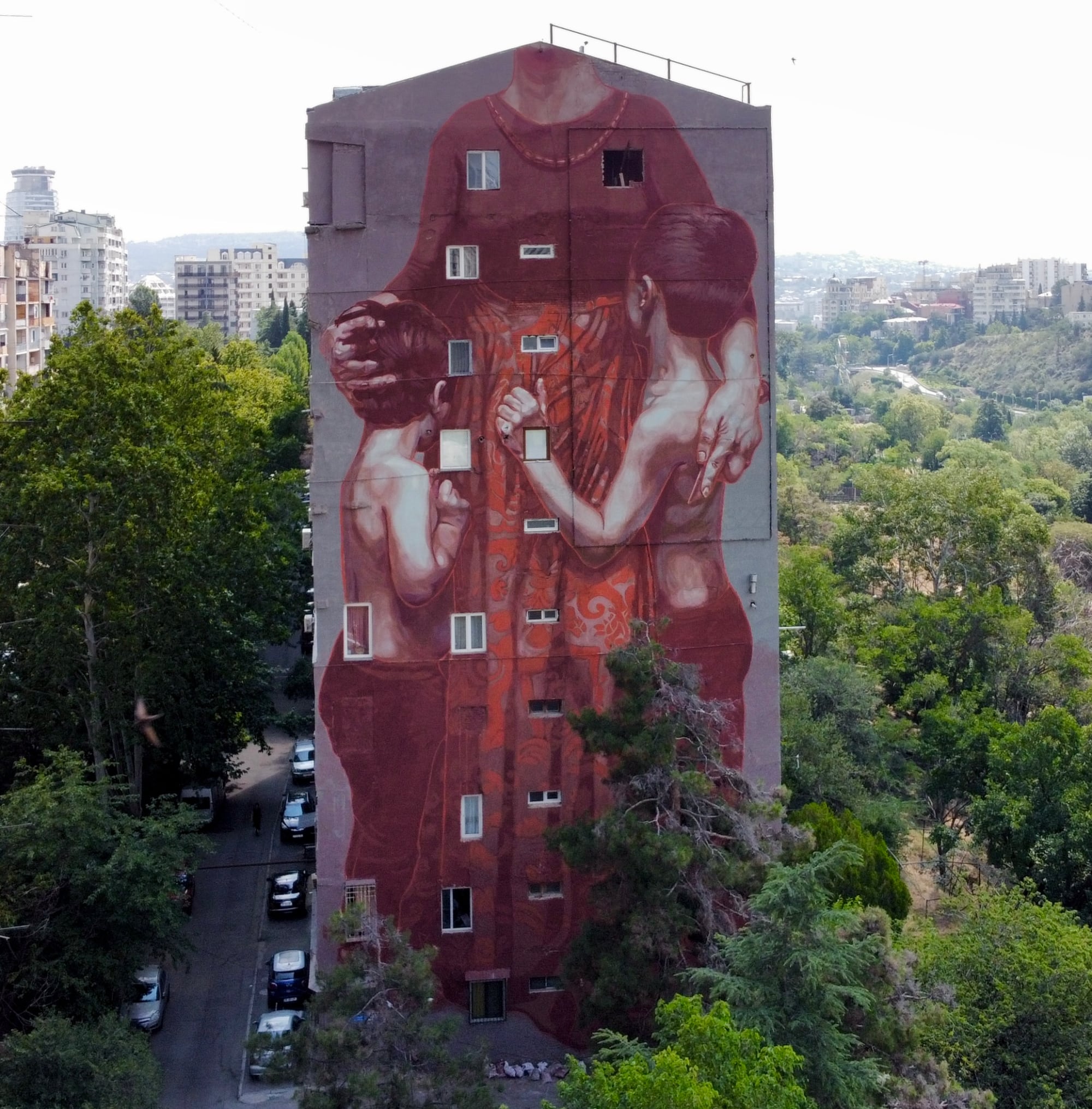a mural of a woman grabbing her two children